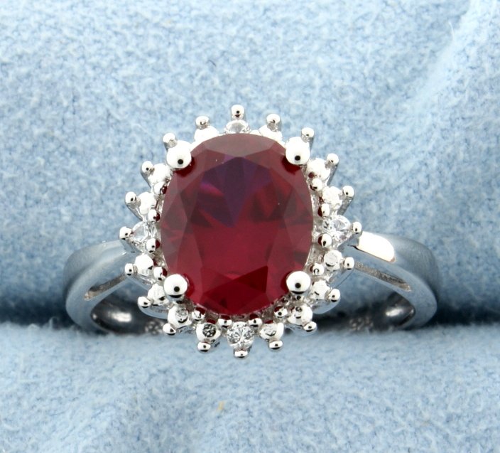 Sterling silver ring with Lab Ruby: Classic and stunning Princess Diana style ring with fantastic oval cut lab Ruby at the center and surrounded by sparkling white sapphires. Size 8 3.1g