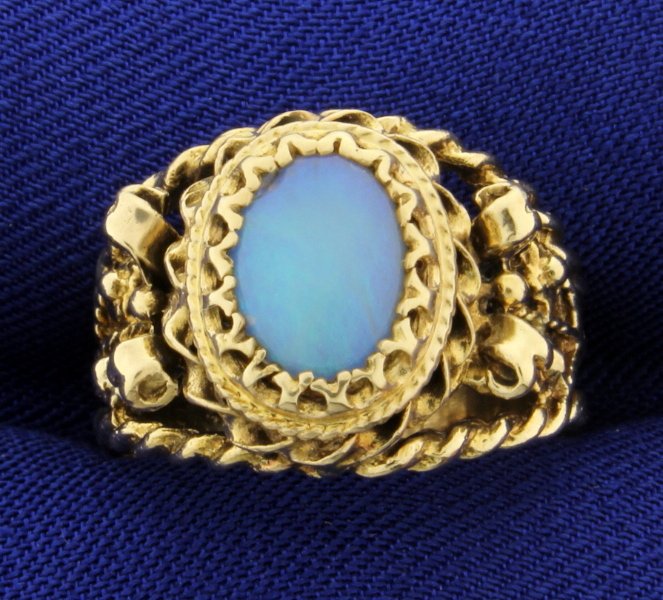 Vintage Opal Ring: In 14K yellow gold there is a 9x7 oval opal gemstone with great detail on shank. Size 6 3/4 6.0g