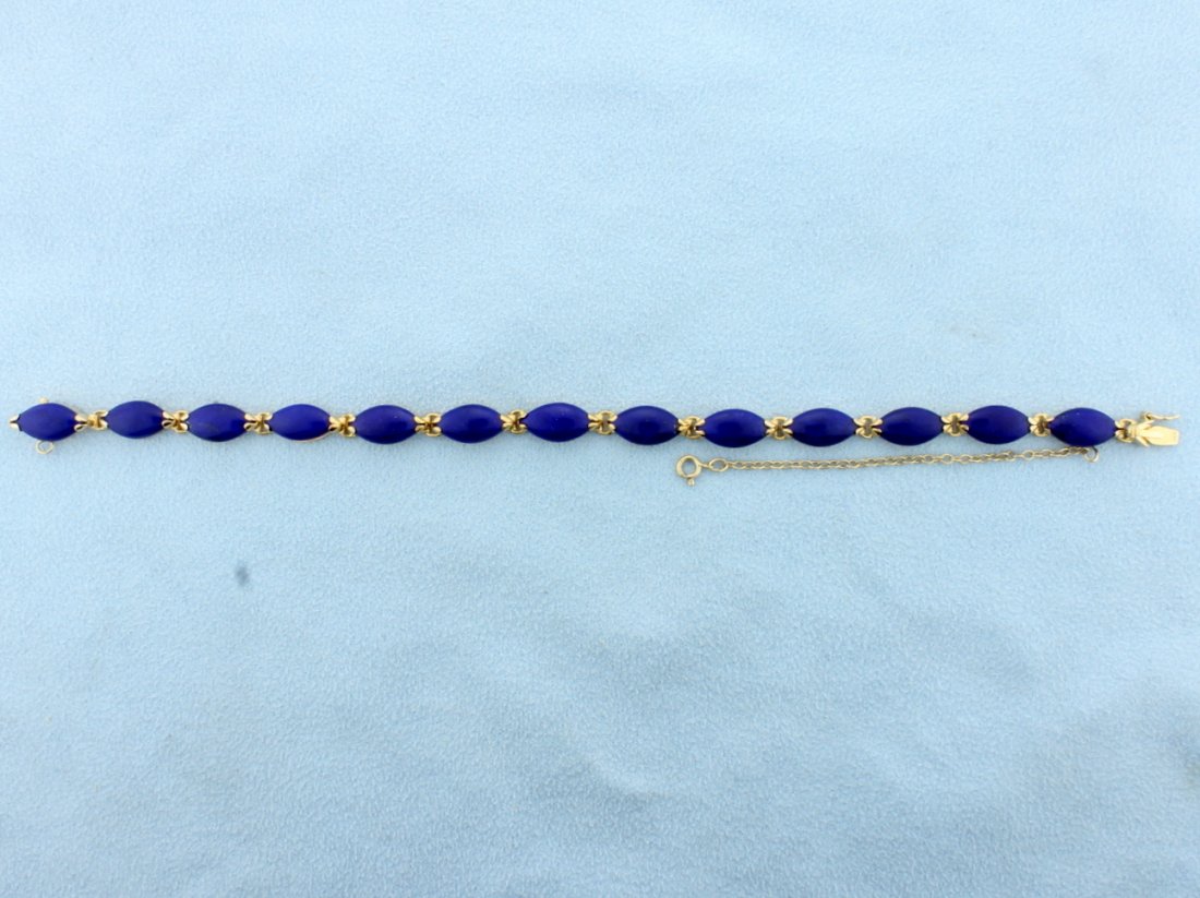 Lapis Bracelet: 14K yellow gold. 12x6mm lapis stones, safety clasp & chain. 7" long. 9.4g