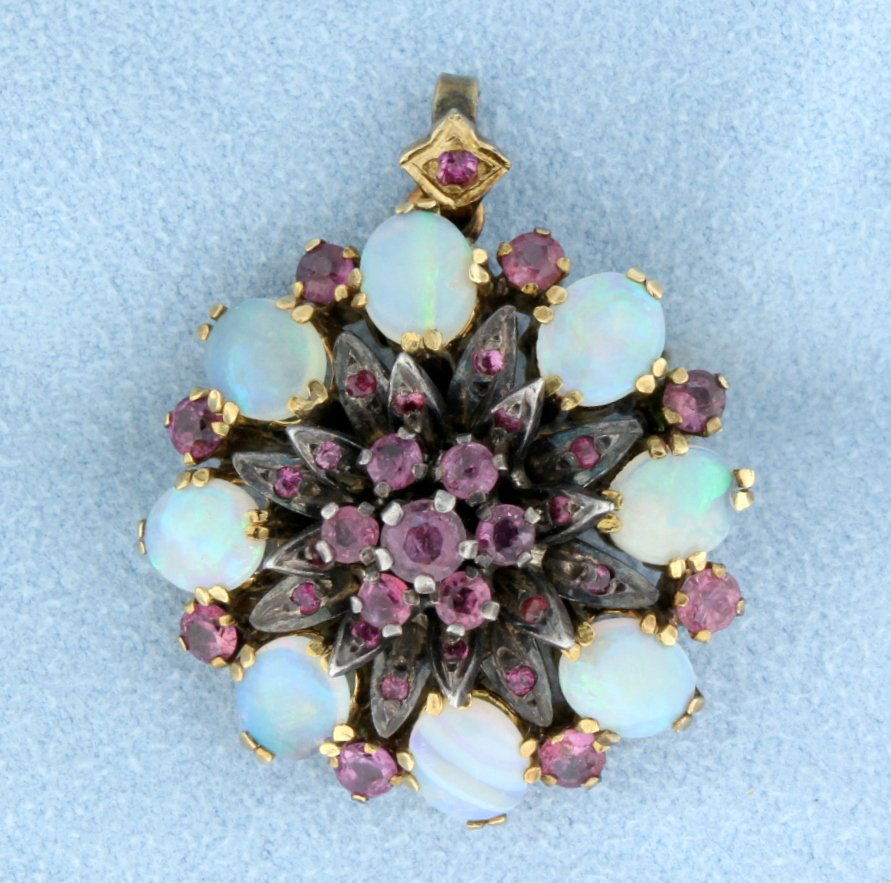 Antique Opal & Ruby pendant/pin: Spectacular Antique Opal and Ruby pendant/pin in 14k yellow gold--this is a fabulous piece for its age. There are 8 Australian oval 7mm x 5mm with fantastic colors--Blues, Greens and Red! There are 31