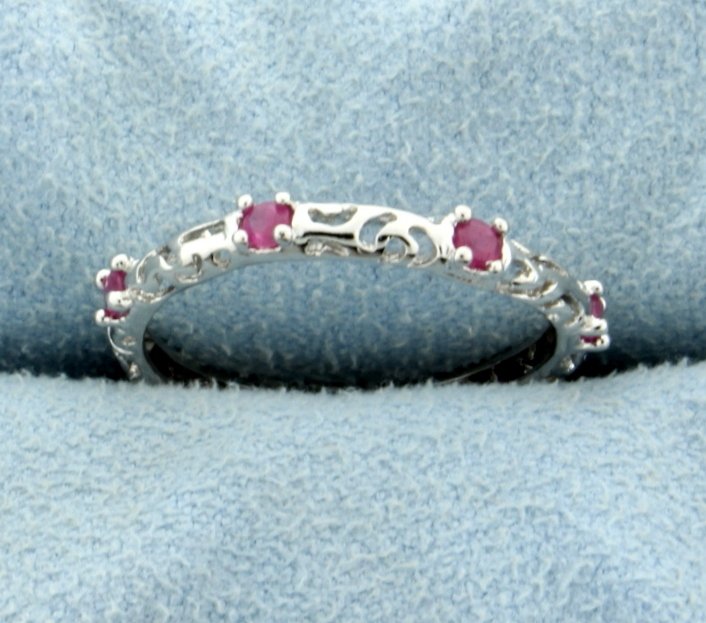 Genuine Ruby Ring set in Sterling Silver: Contains .35 ct TW of genuine Ruby gemstones set in platinum over sterling silver. Size 7.5. 1.2g.
