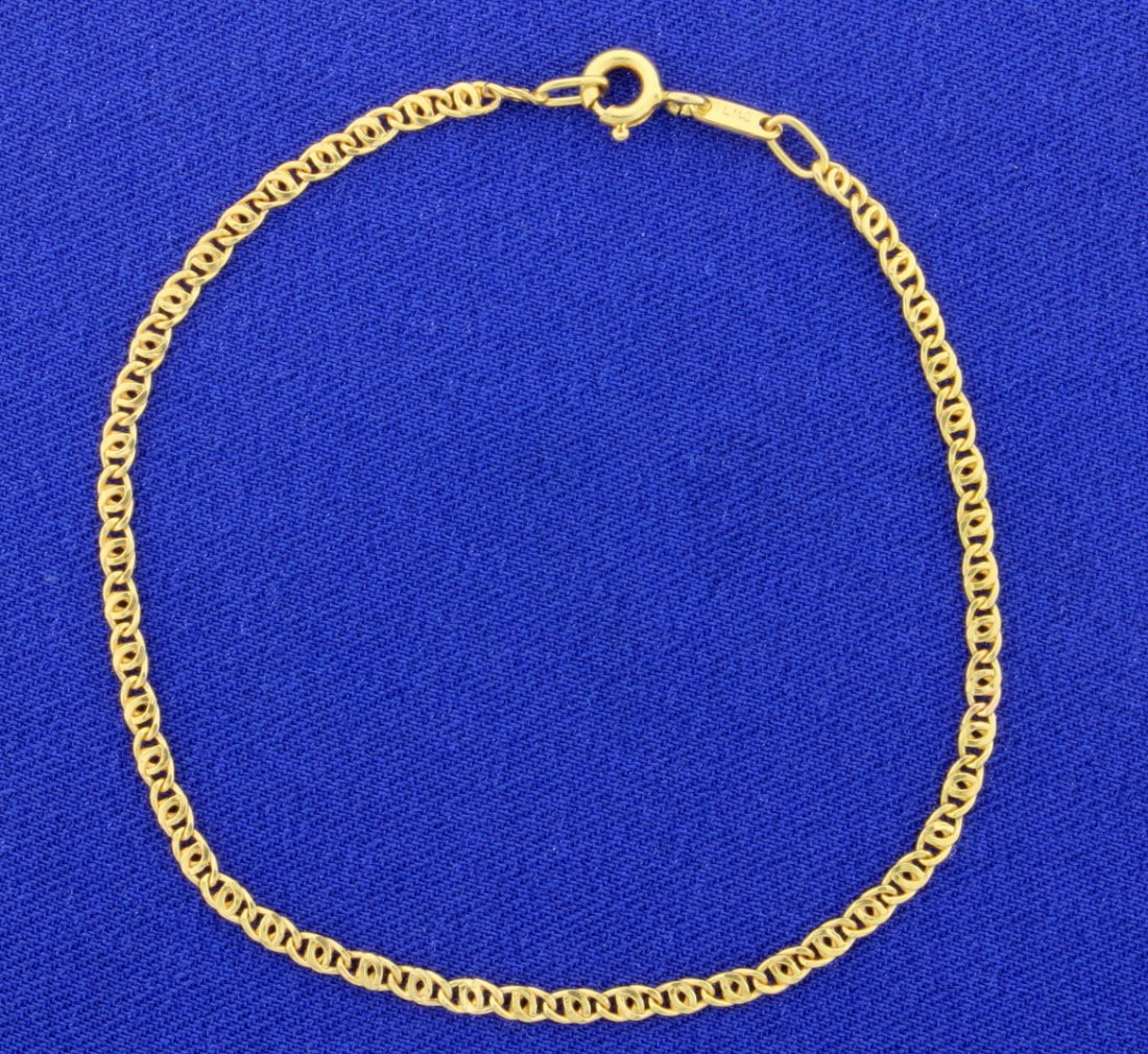 14K Anchor Chain Bracelet: This 14K yellow gold bracelet is 7 1/4 inches long and has a lobster clasp. 0.9g