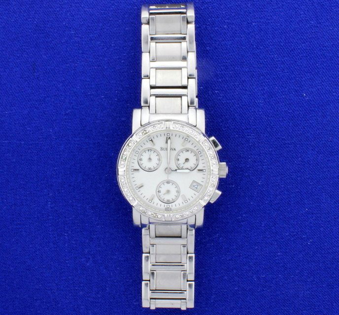 Diamond Bulova Chronograph: Stainless Steel ladies 30 mm diameter watch. The quartz movement watch has all of its links and has a brand new battery. White pealrized idal, bezel has 16 diamonds. Water resistant to 100 feet. Great