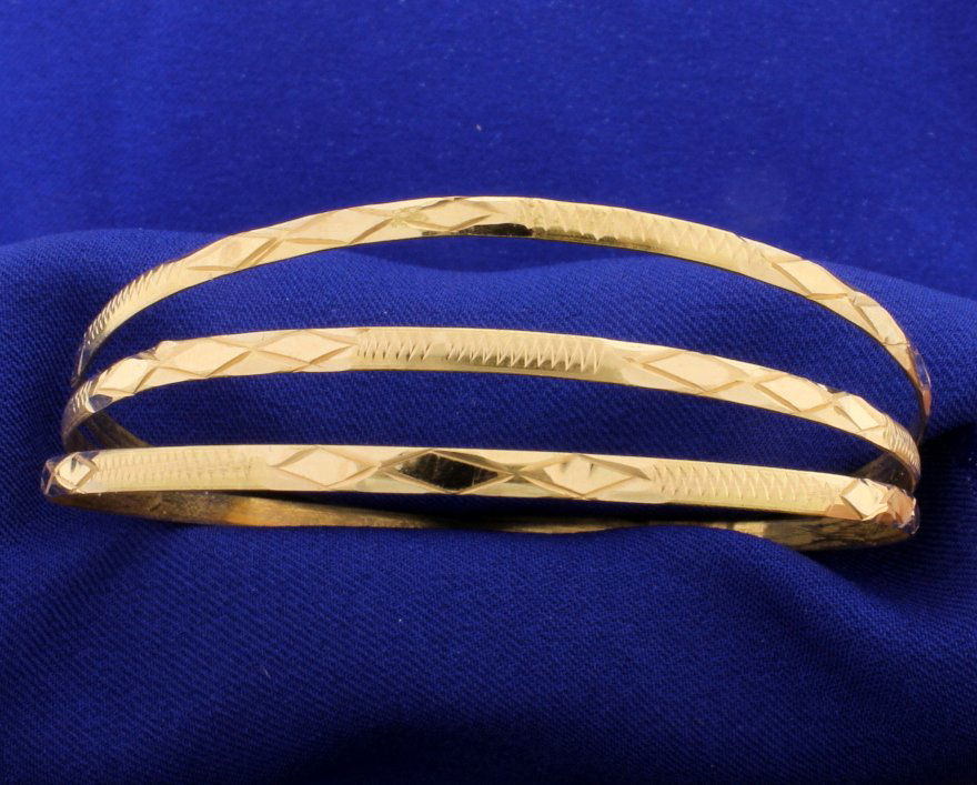 3 Yellow Gold 18k Engraved Bangle Bracelets!: There are three (3) bracelets almost 3mm each in 18k gold. These bracelets are tested to be 18k and are 2-5/8" in diameter. 15.7g