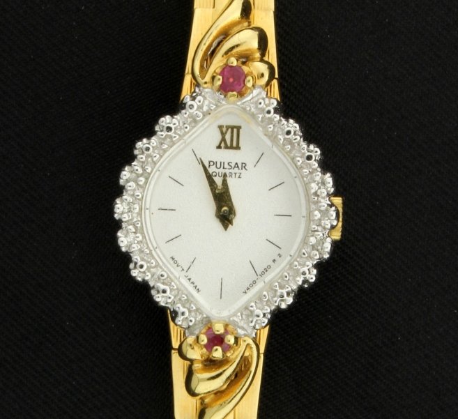 Pulsar Ladies' Watch with Rubies and Diamonds: With Ruby stones at the 12 o'clock and 6 o'clock, and three .01ct diamonds along each side of the face. It has a new battery and runs great!
