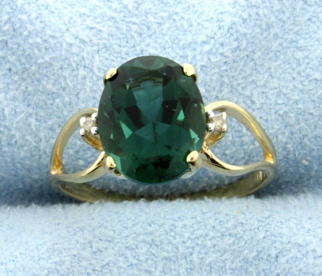Green Quartz & Diamond 10k Ring: The green quartz measures 10.15mmx8.25mm and approx. 3 carats. There are 2 diamonds that weigh 0.02ct TW. Size 5.25. 2.2g