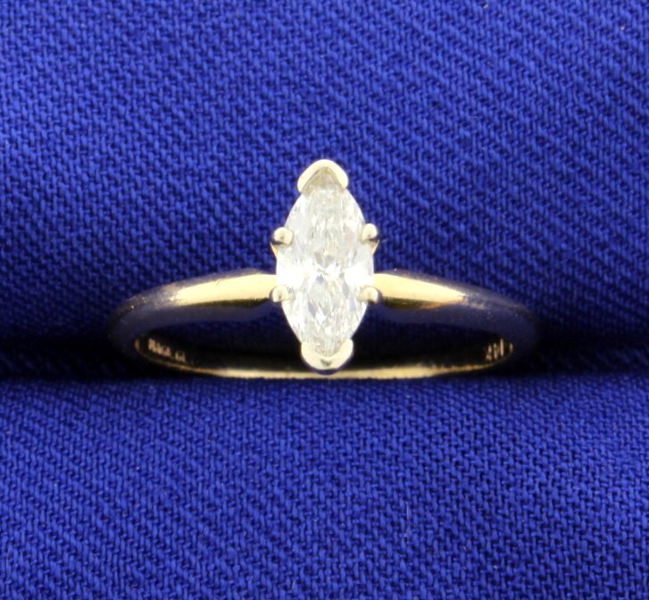 .57 Carat Diamond Solitaire 14k Ring: The diamond is over 1/2 carat and marquise shape with I1 clarity and J-K color. Size 5.75. 1.7g