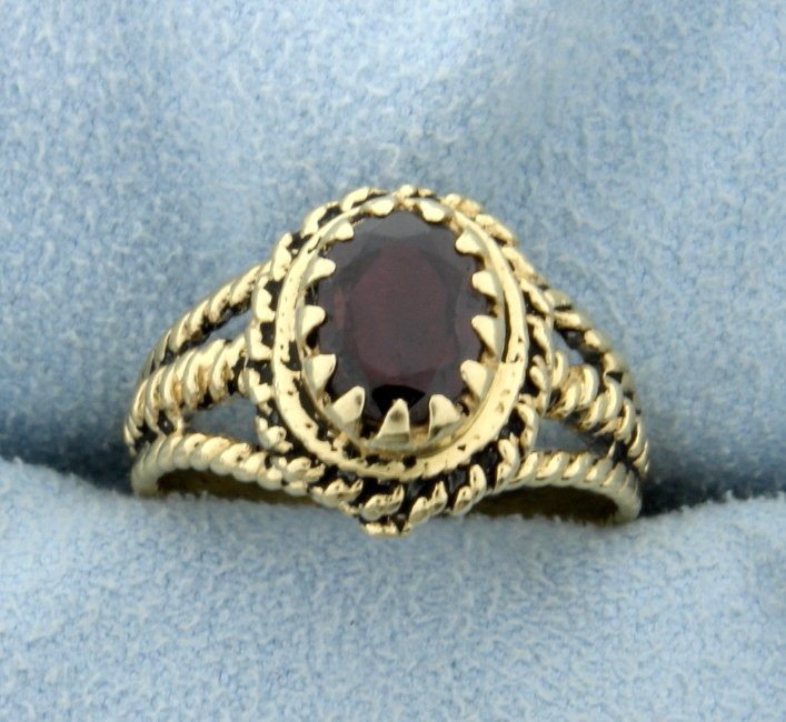 Vintage Garnet Ring: In 14K yellow gold this ring contains a 1.5ct garnet gemstone and is a size 7 1/4. 4.8g