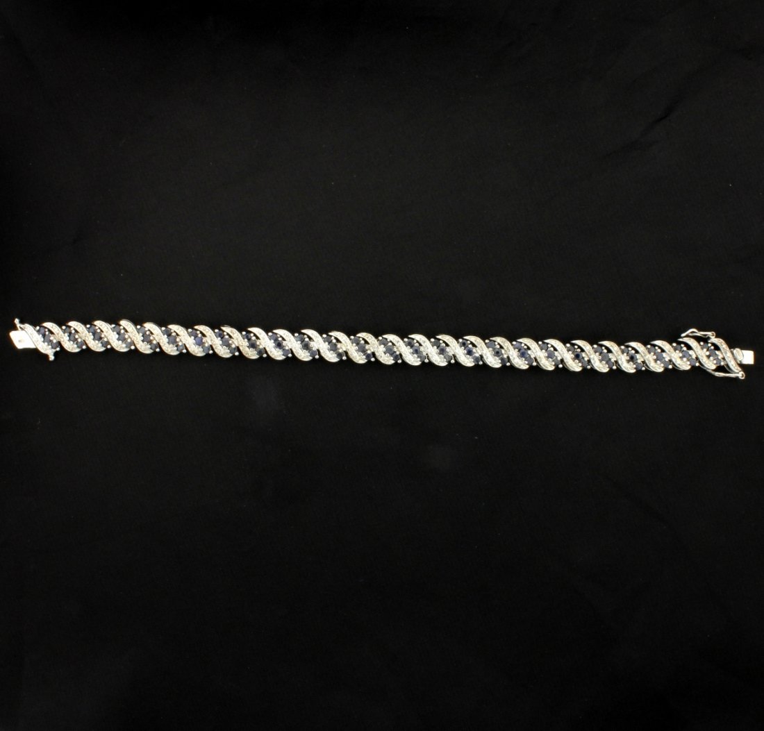 8ct Blue Sapphire Bracelet: In sterling silver, this bracelet contains over 8cts of blue spinel gemstones. It is 7 1/2 inches long. 13.4g