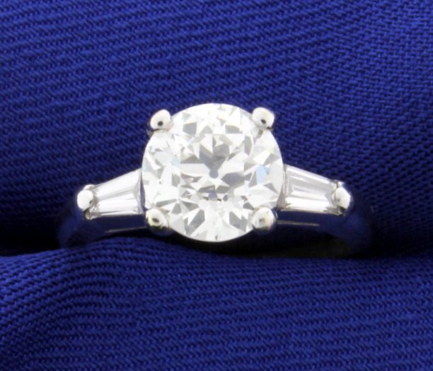 GIA Certified 2 1/2 ct TW Vintage Diamond Ring in: Center Diamond is GIA Certified 2.13 ct Old European Brilliant Cut Diamond. Exceptionally clear VS1 clarity and J color. No flourescence and Very Gold Polish. In a platinum mounting with two .2 ct bag