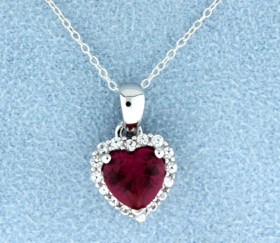 Sterling silver pendant with Lab Ruby: Breath taking sterling silver heart shaped pendant with fantastic lab Ruby heart gemstone set in a Halo of white sapphires that dangles from an 18" sterling silver chain. 2.0g