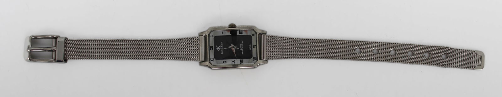 Pre-Owned Calvin Klein Wristwatch: Title: Pre-Owned Calvin Klein Wristwatch Description: This stylish Calvin Klein watch features a rectangular face with Roman numeral markers, complemented by a