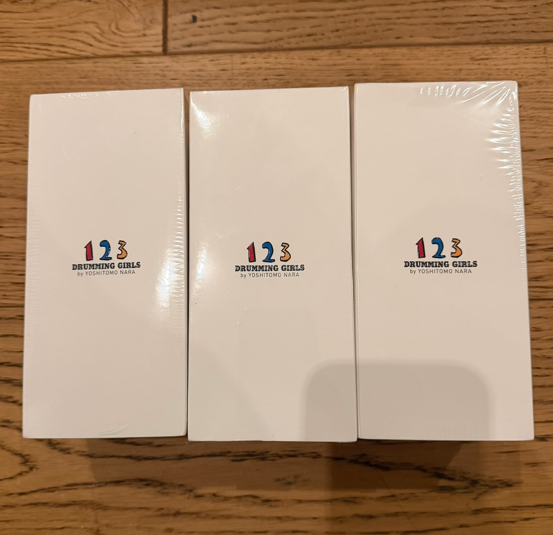 Yoshitomo Nara Drumming Girl 123 Figure Doll Set: Title: Yoshitomo Nara Drumming Girl 123 Figure Doll Set Description: Complete set of 3 – Light Blue, Green, and Red Painted vinyl figurines Each accompanied by their orig