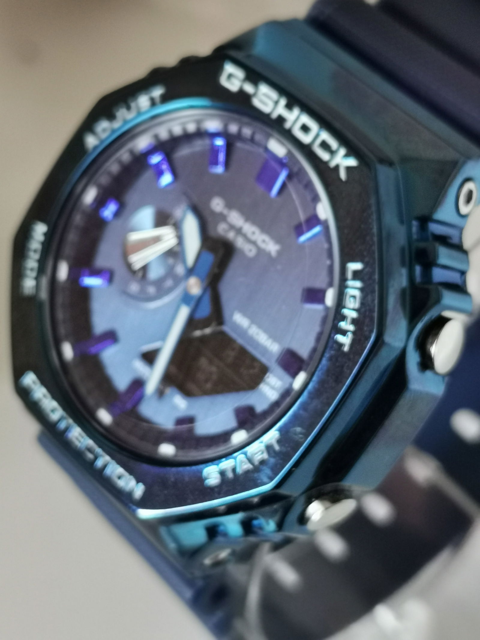 Casio G-Shock GM-2100N-2AER: Title: Casio G-Shock GM-2100N-2AER Description: Casio G-Shock GM-2100N-2AER Men's watch featuring a distinctive octagonal metal-covered bezel in blue with matching blue resin band. Part of the
