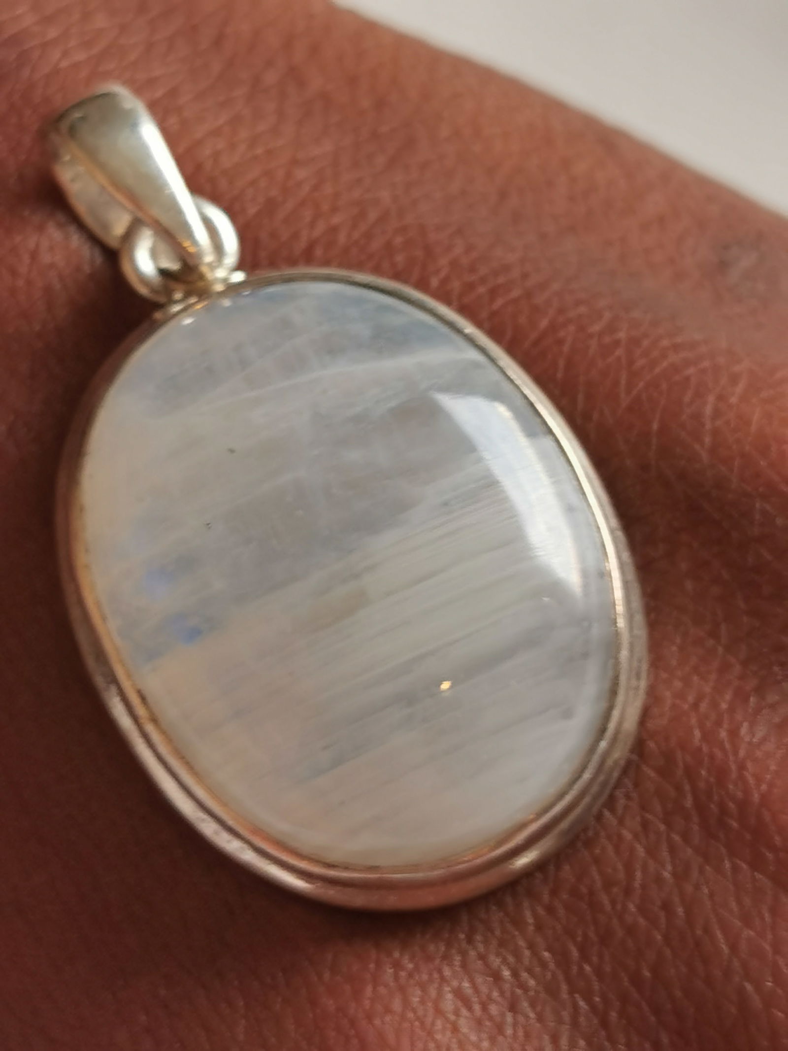 Large Oval Moonstone Pendant In A Simple Sterling‑Silver Bezel.: Title: Large Oval Moonstone Pendant In A Simple Sterling‑Silver Bezel. Description: Large oval moonstone pendant in a simple sterling‑silver bezel. The polished milky‑white