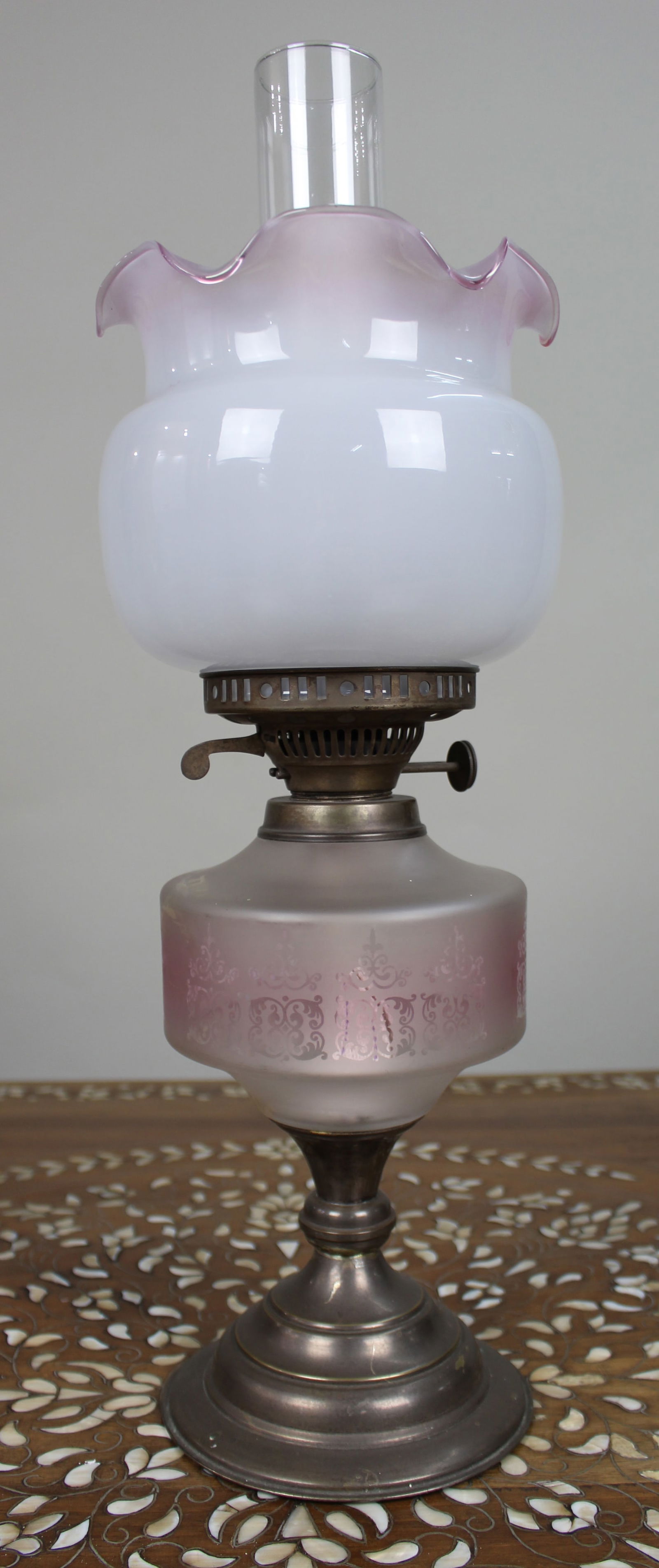 Antique Oil Lamp with Glass Font & Shade: Title:Antique Oil Lamp with Glass Font & Shade Description: Antique Duplex Oil Lamp with Frosted Pink Glass Font and Opaline Shade A charming antique Duplex oil lamp, featuring a frosted glass