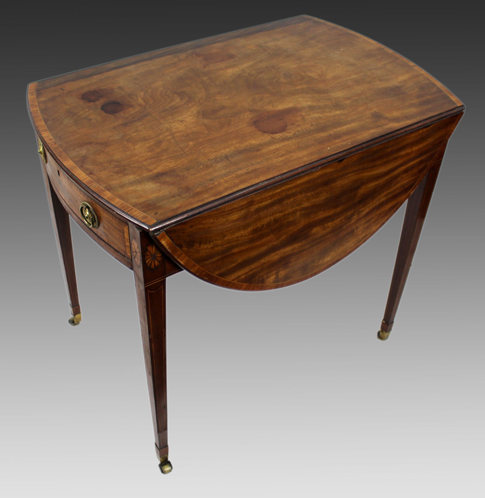 George III Mahogany Pembroke Table: Title:George III Mahogany Pembroke Table Description: A George III Mahogany Pembroke Table from the late 18th century. The table features a classic oval top with drop leaves to either side