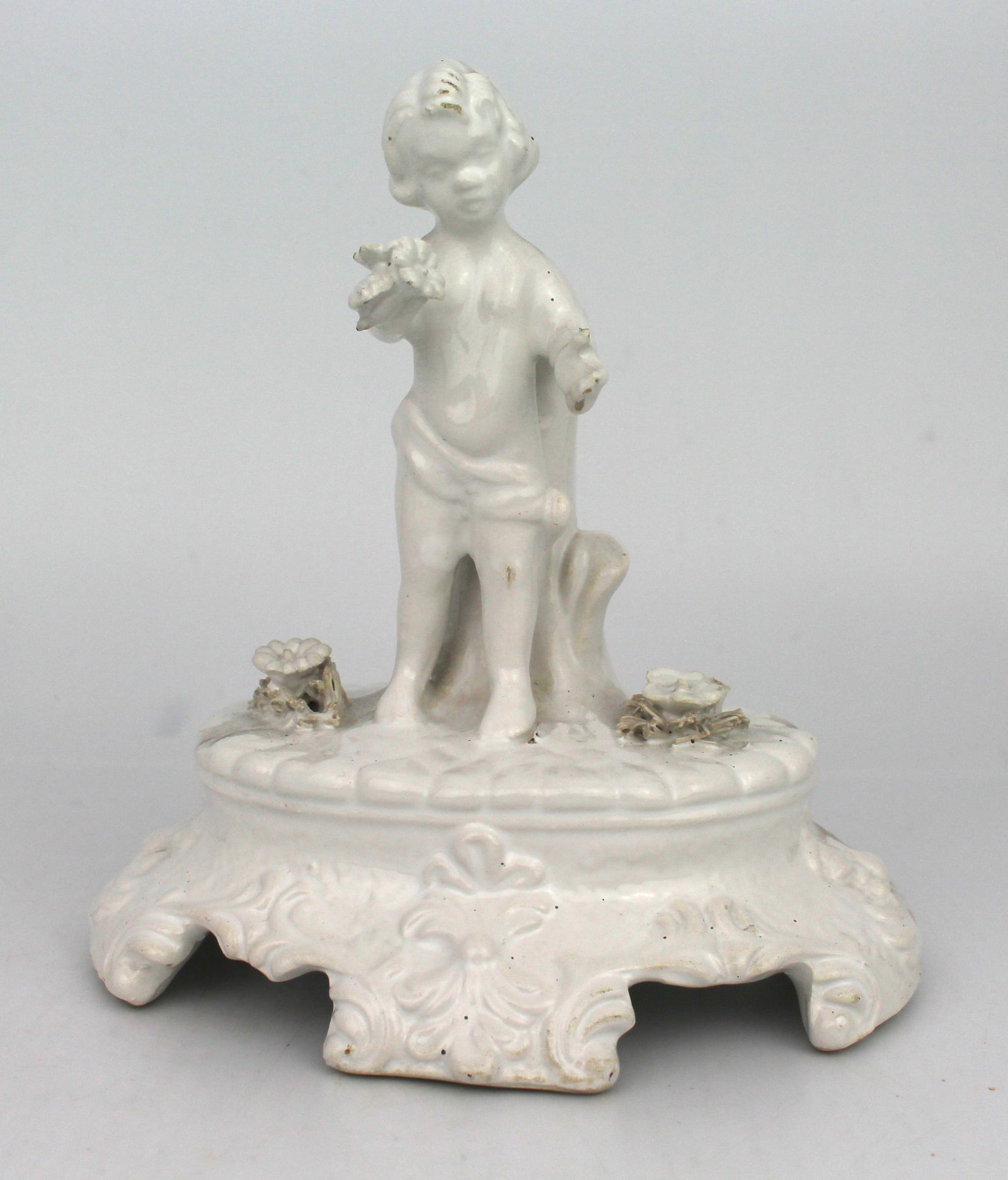 Painted White Porcelain Cherub Figurine: Title:Painted White Porcelain Cherub Figurine Description: Painted White Porcelain Cherub Figurine. Measures 14 x 11 x 14 (height) cm. Very good condition
