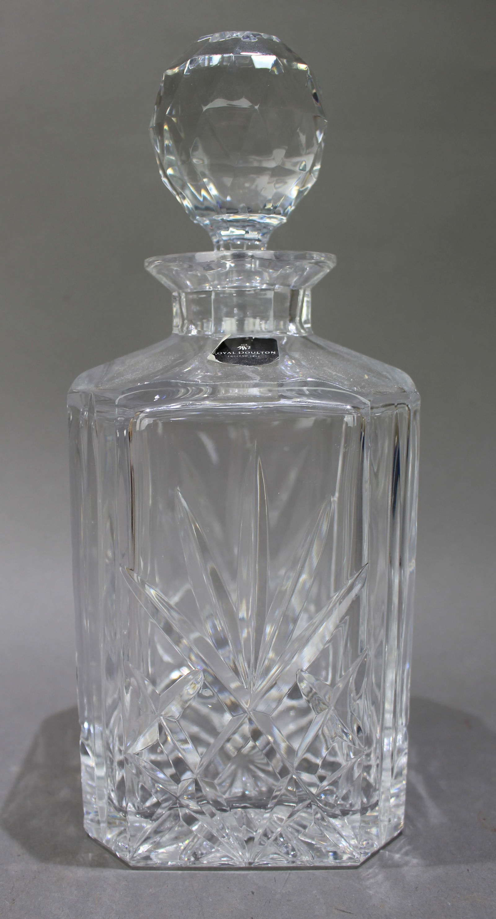 Vintage Royal Doulton Crystal Square Shaped Spirit Decanter: Title:Vintage Royal Doulton Crystal Square Shaped Spirit Decanter Description: Vintage Royal Doulton Crystal Square Shaped Spirit Decanter. Factory label to decanter. Measures 10 x 10
