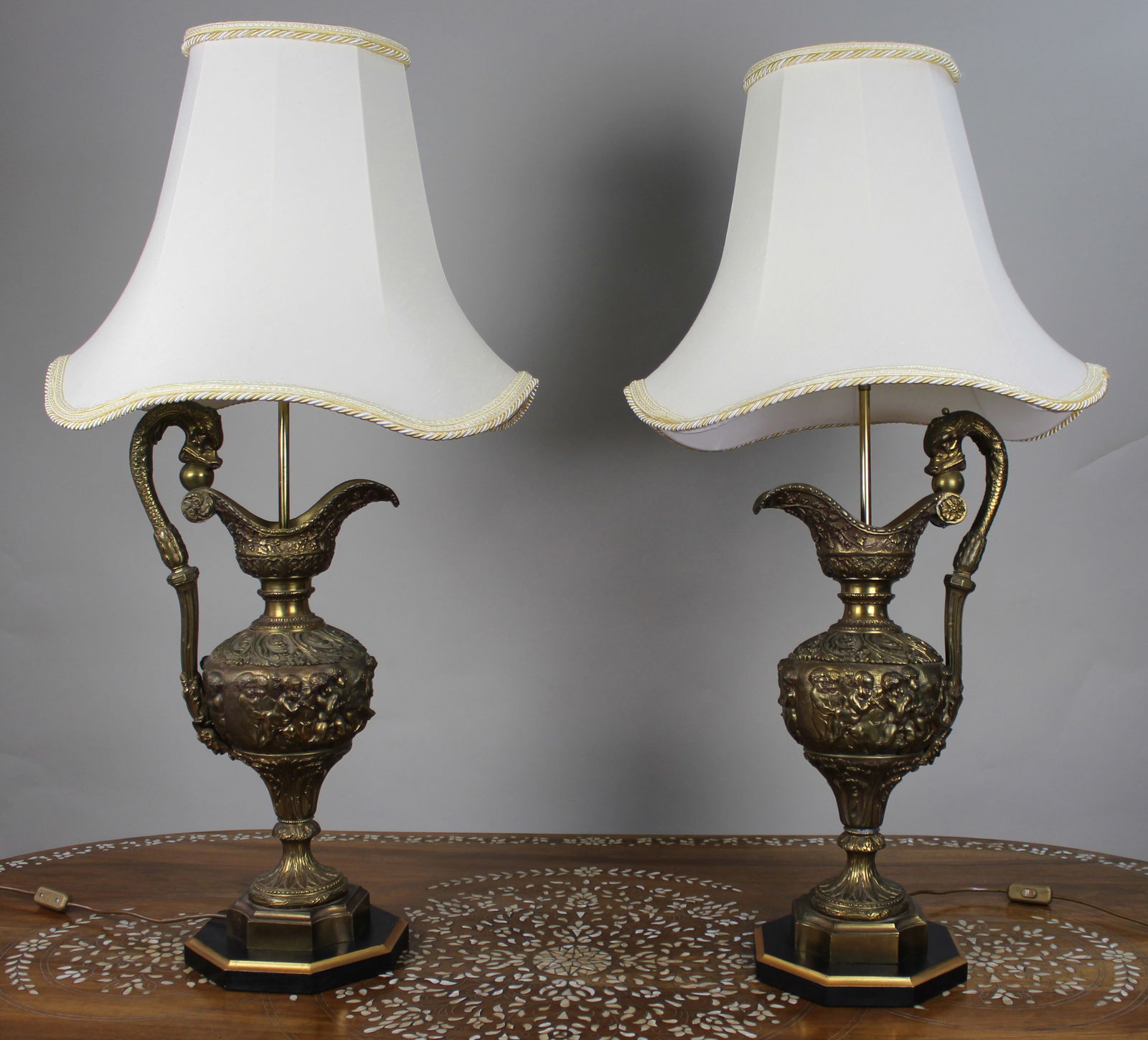Pair of Early 20th Century French Neoclassical Ewer Lamps with Putti Relief: Title:Pair of Early 20th Century French Neoclassical Ewer Lamps with Putti Relief Description: Pair of Early 20th Century French Neoclassical Ewer Lamps with Putti Relief We are pleased to offer a