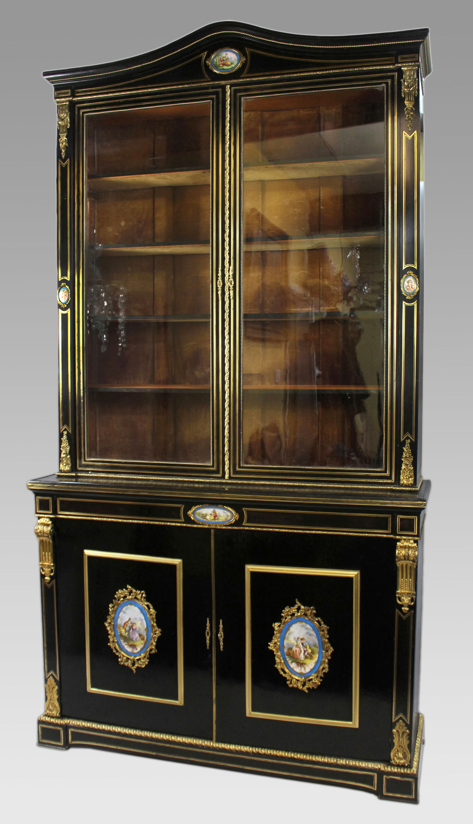 French Brass Inlaid Ebonized Bookcase with Sevres Plaques c.1820: Title:French Brass Inlaid Ebonized Bookcase with Sevres Plaques c.1820 Description: French Ebonized Bookcase with Sevres Plaques, Circa 1820 This elegant French ebonized bookcase, dating to