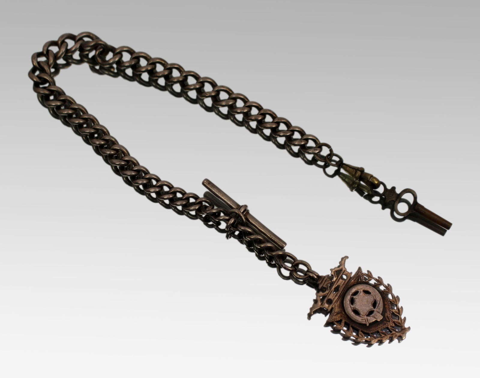 Victorian Sterling Silver Albert Watch Chain: Title: Victorian Sterling Silver Albert Watch Chain Description: Victorian Sterling Silver Albert Watch Chain with Football Medal Fob and Key English, Birmingham 1896, C.E.S. A fine and