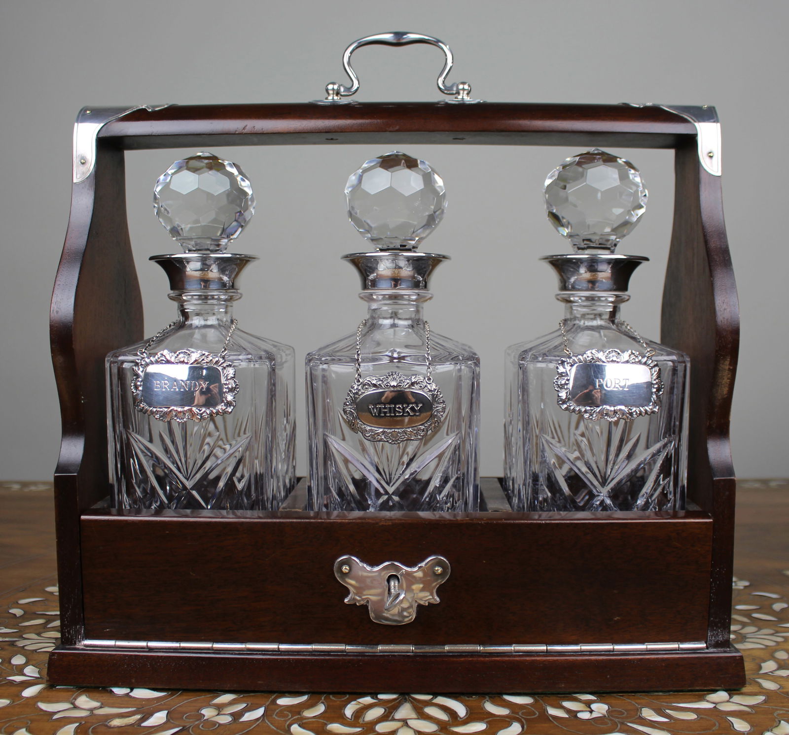 Vintage Mahogany Three Bottle Cut Crystal Tantalus with Silver Plated Mounts: Title: Vintage Mahogany Three Bottle Cut Crystal Tantalus with Silver Plated Mounts Description: Vintage Three Bottle Cut Crystal Tantalus with Silver Plated Mounts A finely made vinta