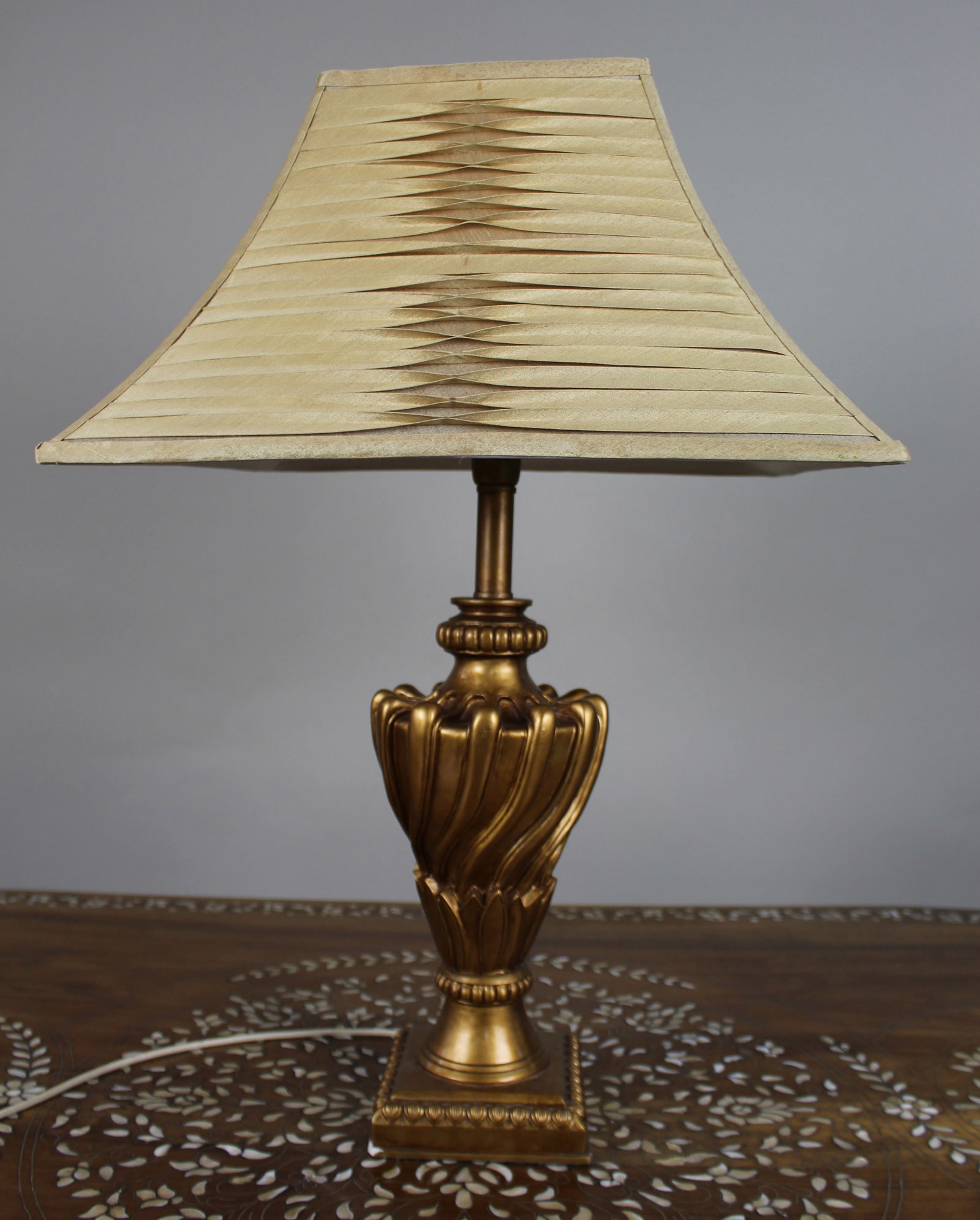 Vintage Gilt Table Lamp with Pleated Shade: Title: Vintage Gilt Table Lamp with Pleated Shade Description: Vintage Gilt Table Lamp with Pleated Shade A decorative vintage table lamp with an ornate gilt base of classical form.