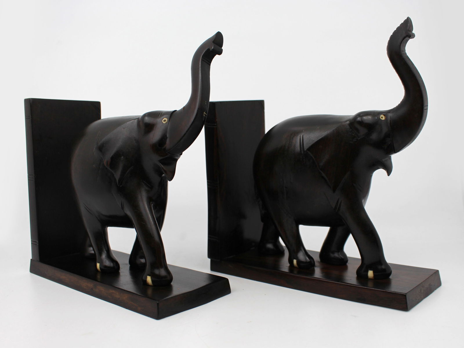 Pair of Antique African Carved Hardwood Elephant Bookends: Title: Pair of Antique African Carved Hardwood Elephant Bookends Description: Mid-20th Century African Carved Hardwood Elephant Bookends A well-proportioned and finely hand-carved pair