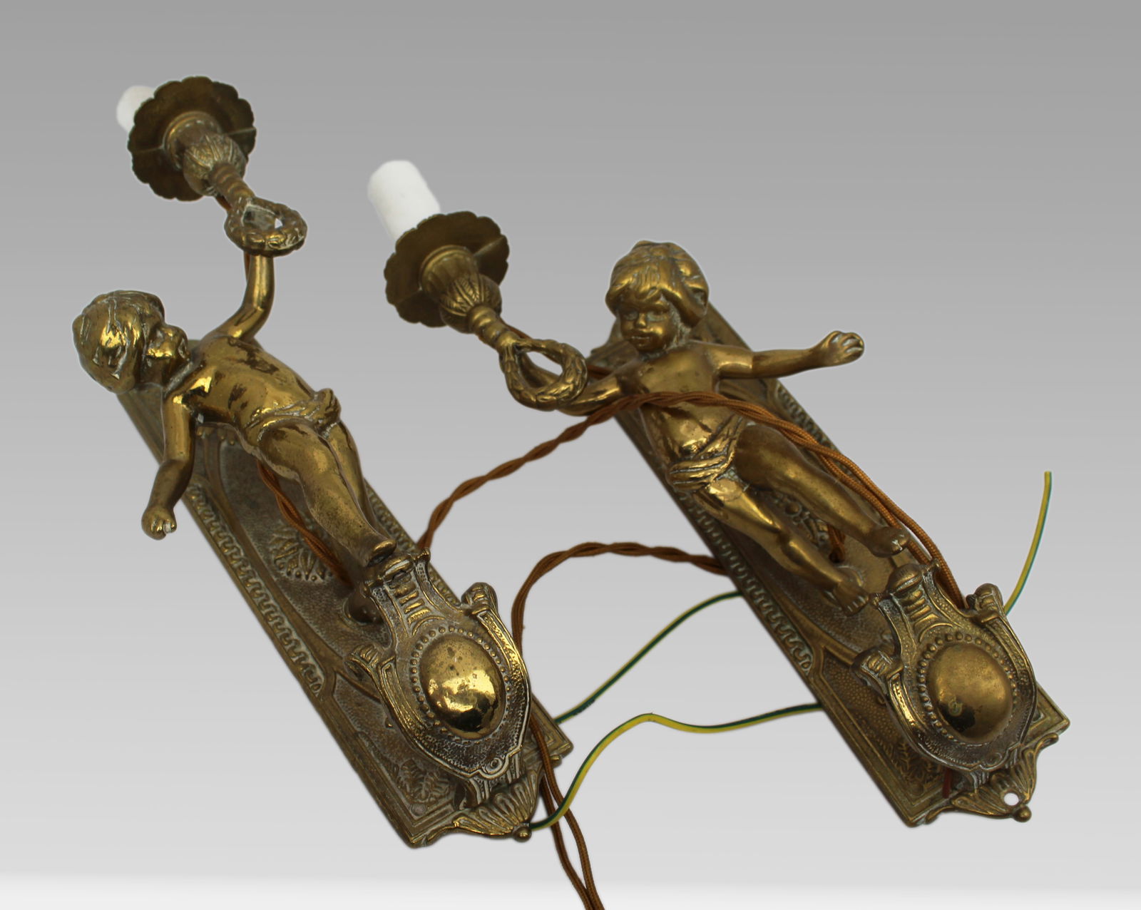 Pair of Quality Brass Cherub Form Wall Lights: Title: Pair of Quality Brass Cherub Form Wall Lights Description: Fine Pair of Mid-20th Century Brass Wall Lights with Cherub Figures Description: A decorative pair of wall-mounted brass
