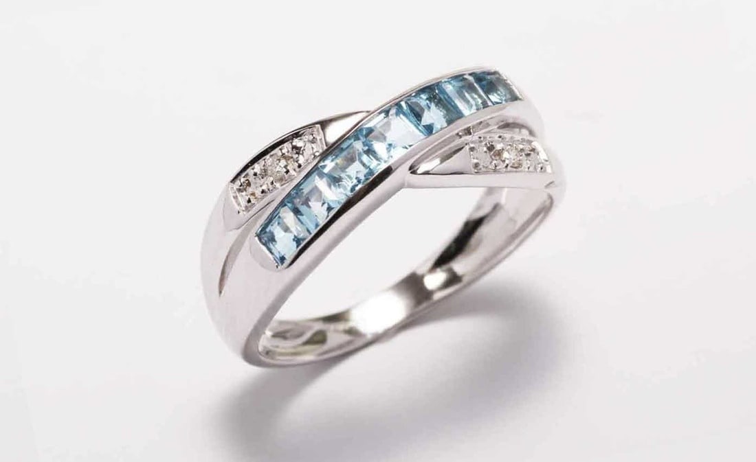 This Twist On A Classic Ring Is Stunning. Seven Beautiful Princess Cut Blue Topaz Gemstones: Title: This Twist On A Classic Ring Is Stunning. Seven Beautiful Princess Cut Blue Topaz Gemstones Description: This twist on a classic ring is stunning. Seven beautiful princess cut blue