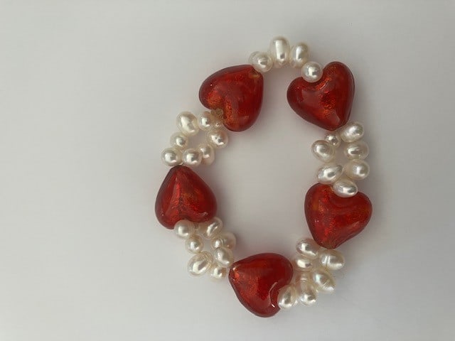 Pearl Love Heart Bracelet: Title: Pearl Love Heart Bracelet Description: Excellent condition as hardly worn. I have been told that they are salt water pearls but unsure. 7 inches or so as shown. 40 pearls in total. 