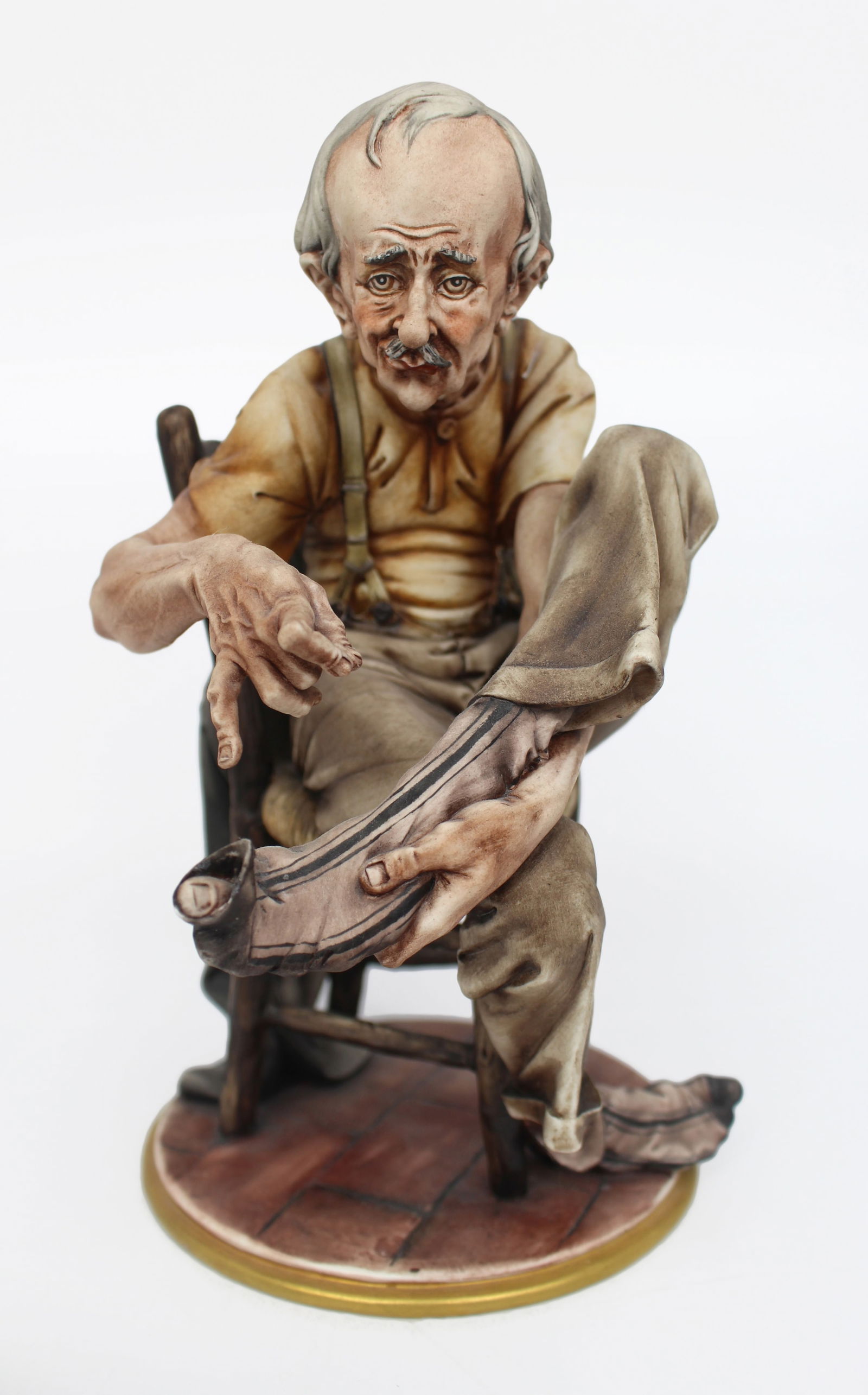 Capodimonte Tramp Darning His Socks: Title: Capodimonte Tramp Darning His Socks Description: Capodimonte Tramp Darning His Socks Capodimonte, made in Italy. Mid/late 20th century. To the base I.R.A Usmate. Measures 15 x 18 x 25