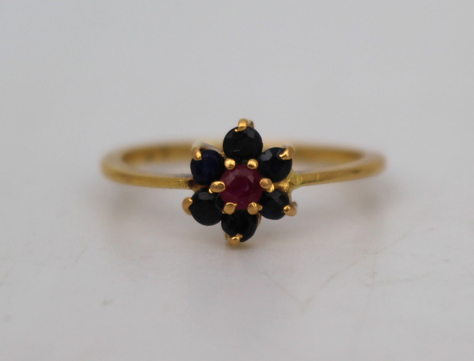 Vintage Ruby and Sapphire Cluster Ring in High Carat Gold: Title: Vintage Ruby and Sapphire Cluster Ring in High Carat Gold Description: Vintage Ruby and Sapphire Cluster Ring in High Carat Gold This charming vintage ring features a central ruby