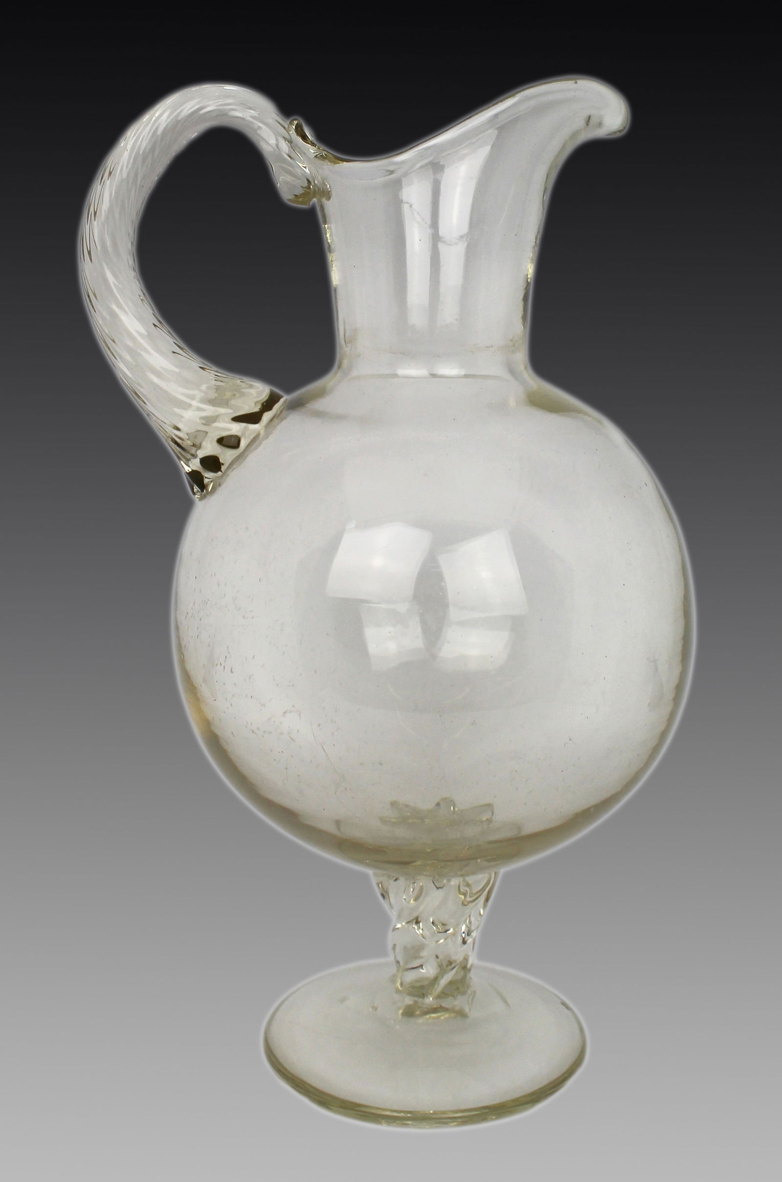 Antique Glass Footed Ewer, Late 19th Century: Title: Antique Glass Footed Ewer, Late 19th Century Description: Antique Glass Footed Ewer, Late 19th Century This antique glass footed ewer, dating from the late 19th century, features a
