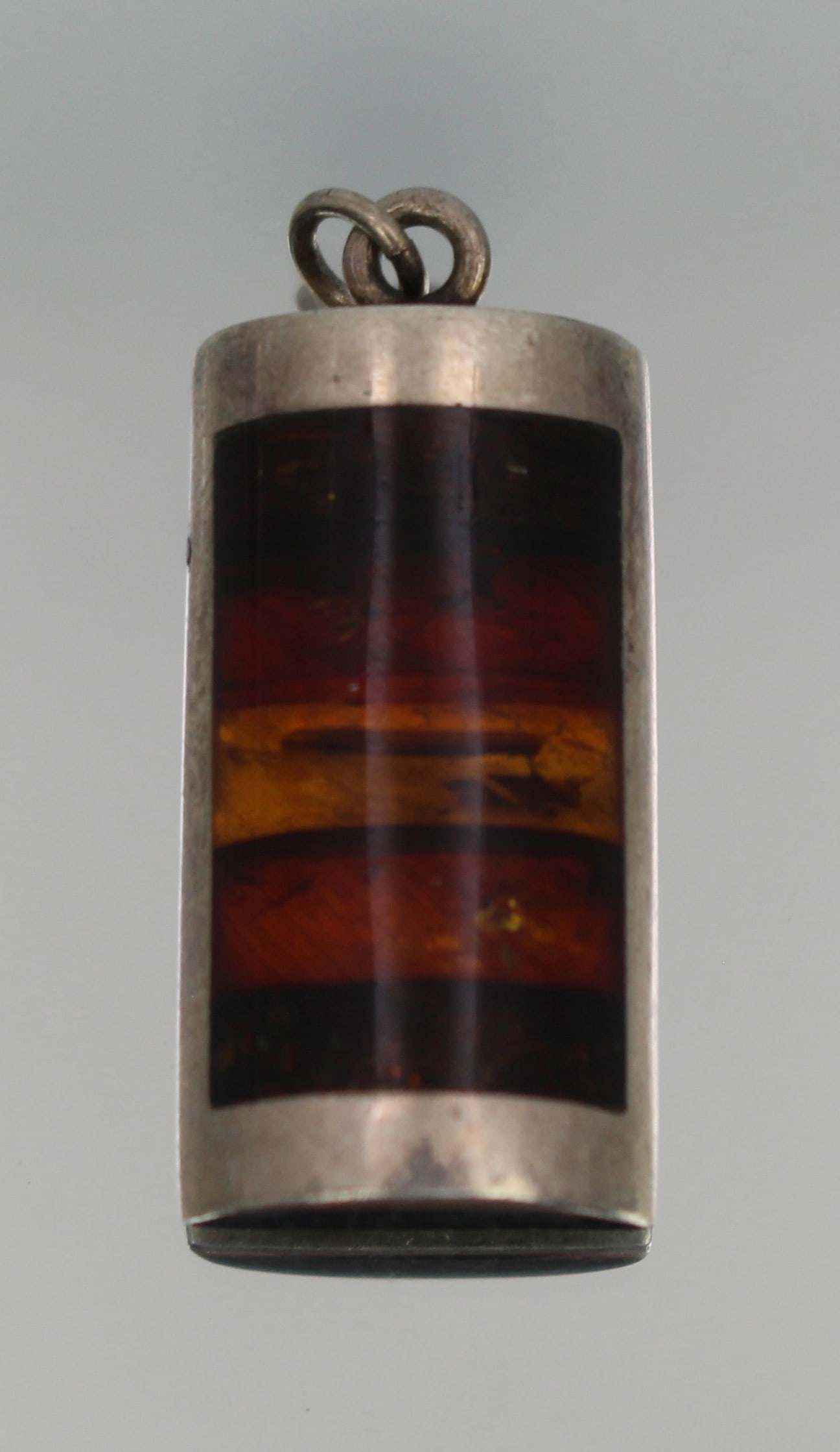 Vintage Modernist Baltic Amber and Silver Pendant: Title: Vintage Modernist Baltic Amber and Silver Pendant Description: Vintage Modernist Baltic Amber and Silver Pendant A stylish vintage pendant of modernist design, featuring a curved