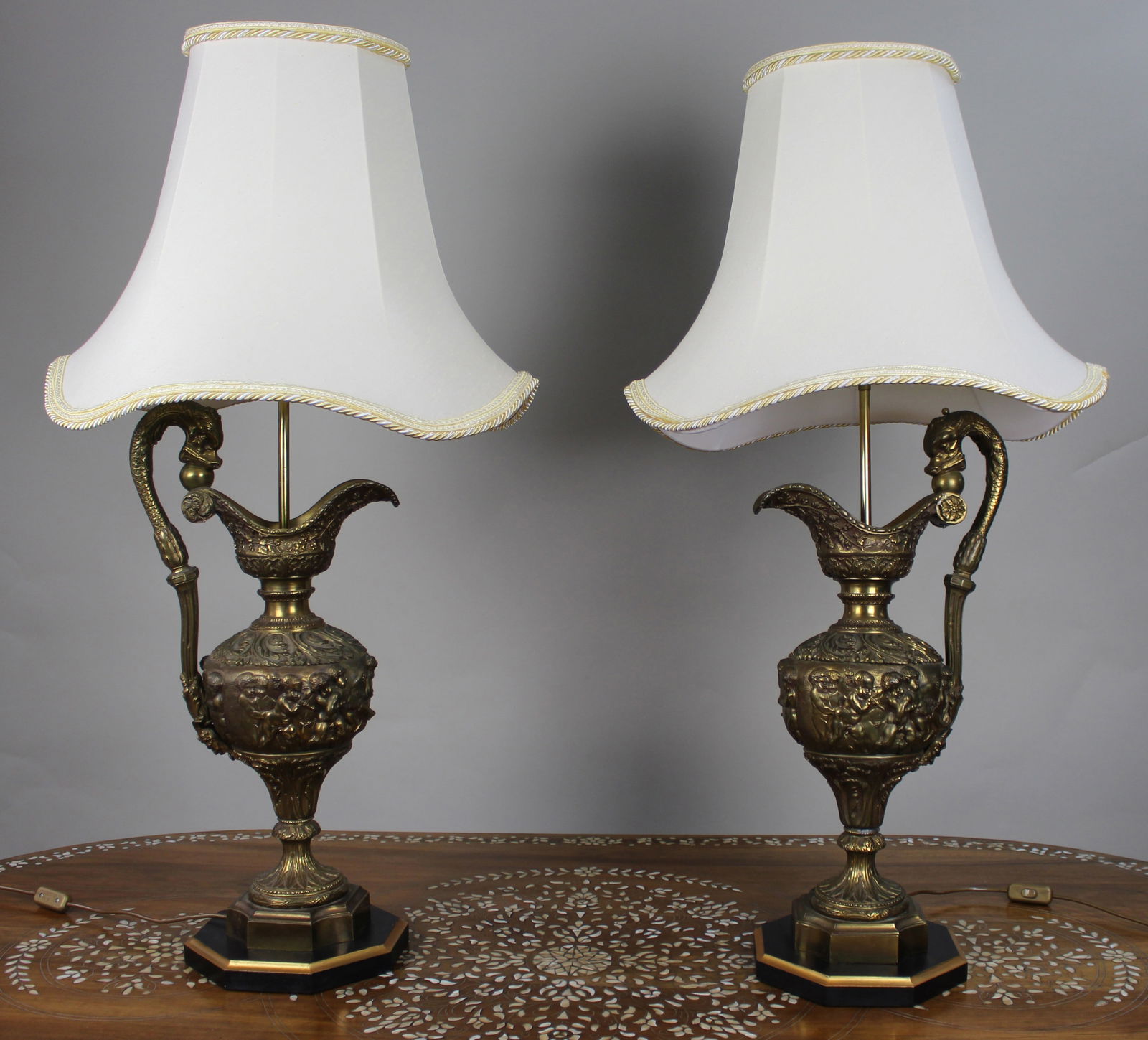 Pair of Early 20th Century French Neoclassical Ewer Lamps with Putti Relief: Title: Pair of Early 20th Century French Neoclassical Ewer Lamps with Putti Relief Description: Pair of Early 20th Century French Neoclassical Ewer Lamps with Putti Relief We are pleased to