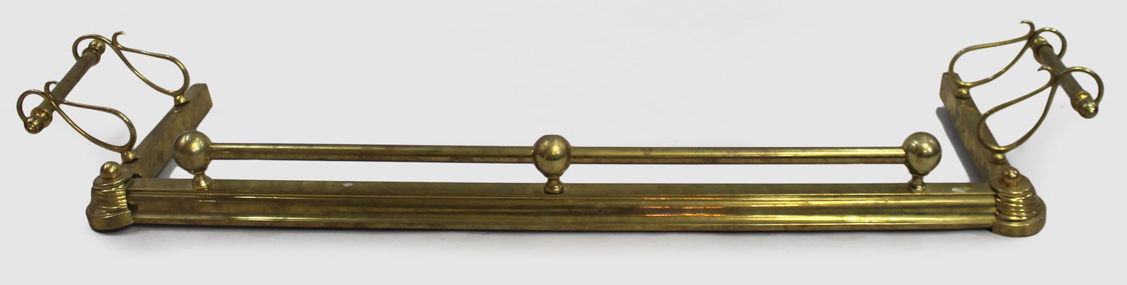 Antique Brass Fire Fender with Outswept Fire Iron Rests: Title: Antique Brass Fire Fender with Outswept Fire Iron Rests Description: Antique Brass Fire Fender with Outswept Fire Iron Rests English, late 19th century, c.1890 A well-proportioned antique