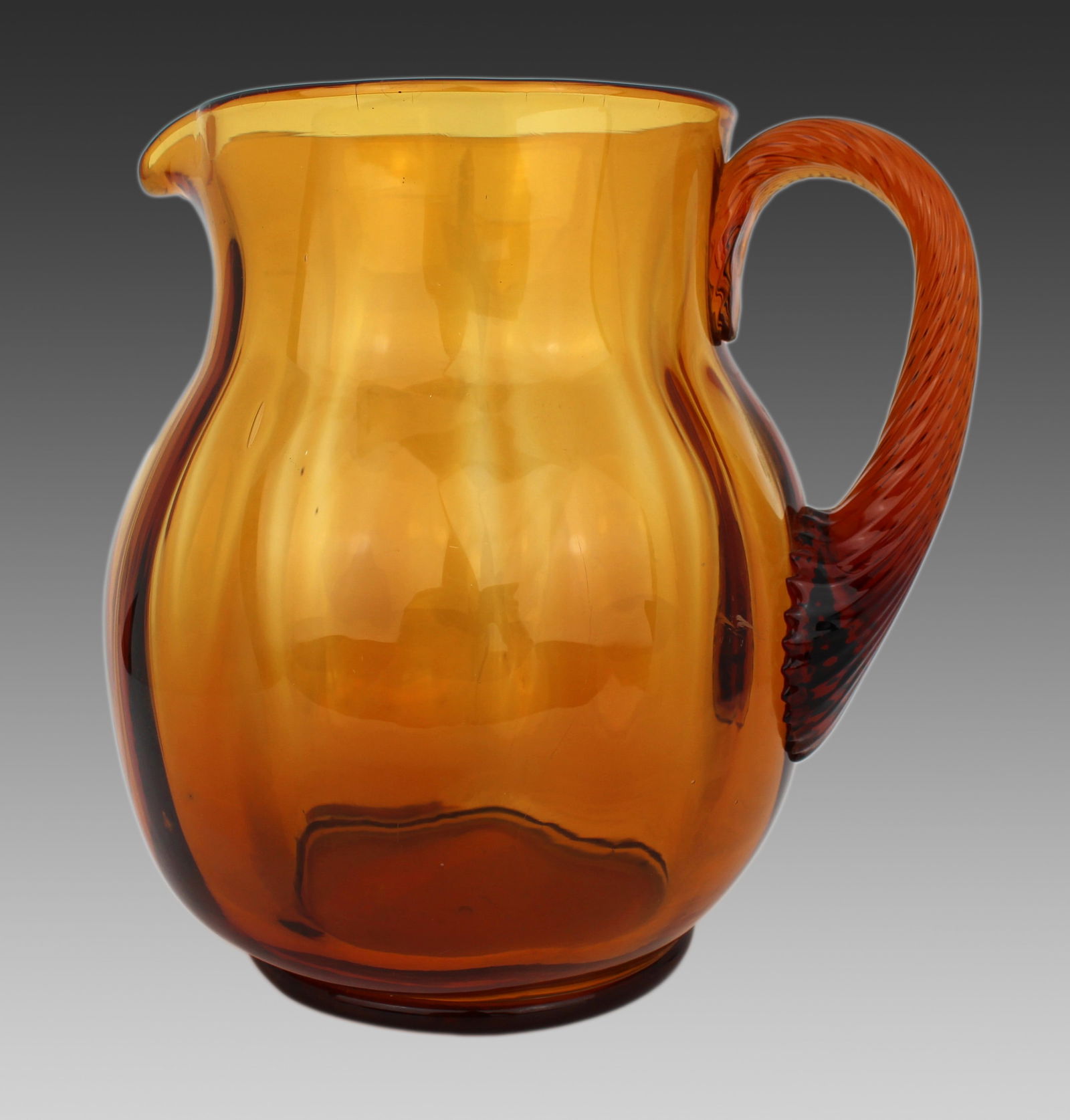 Large Amber Glass Jug c.1940: Title: Large Amber Glass Jug c.1940 Description: Large Amber Glass Jug, c.1940 A good large hand-blown amber glass jug, of rounded form with lobed body and applied ribbed handle. Ground and