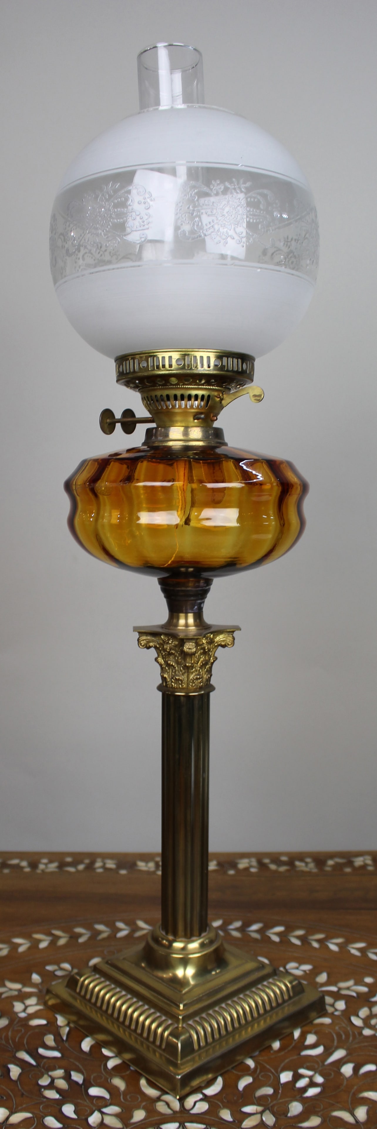 Victorian Brass Oil Lamp with Amber Glass Font: Title: Victorian Brass Oil Lamp with Amber Glass Font Description: Victorian Brass Oil Lamp with Amber Glass Font England, circa 1890 A fine Victorian brass oil lamp of archite