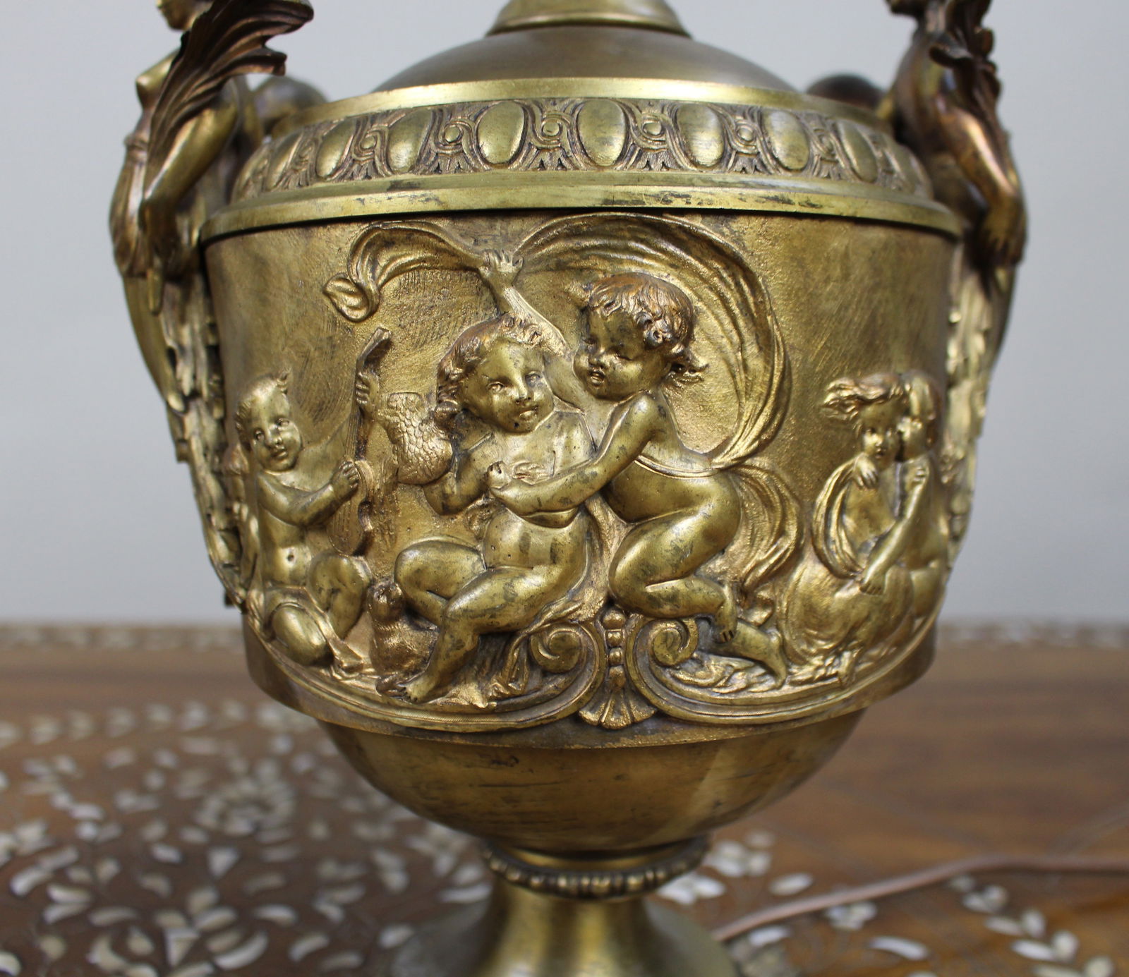 Pair of French Gilt Bronze Urn Lamps with Putti Reliefs, circa 1900 - 10