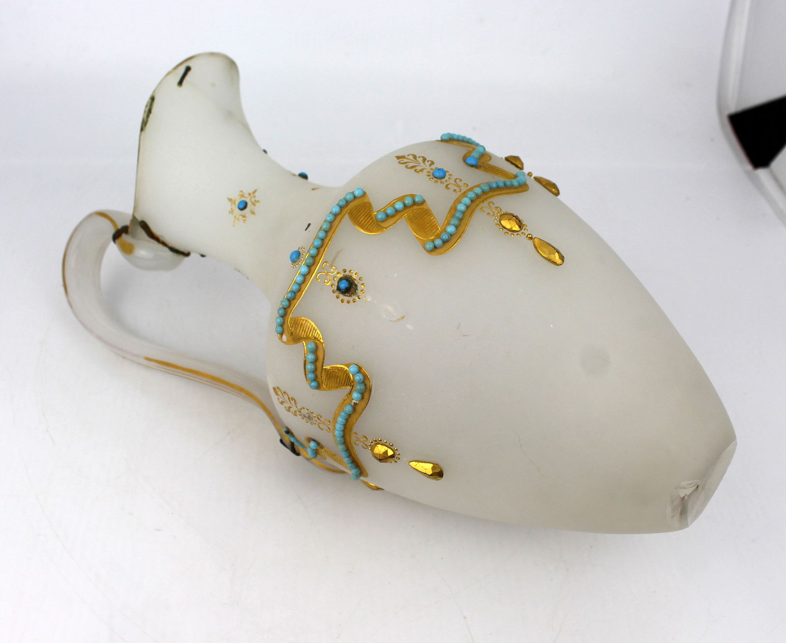 Antique French Bejewelled Turquoise Opaline Ewer A/F: Title: Antique French Bejewelled Turquoise Opaline Ewer A/F Description: This charming antique French opaline glass ewer features delicate gold leaf detailing and turquoise accents, a style