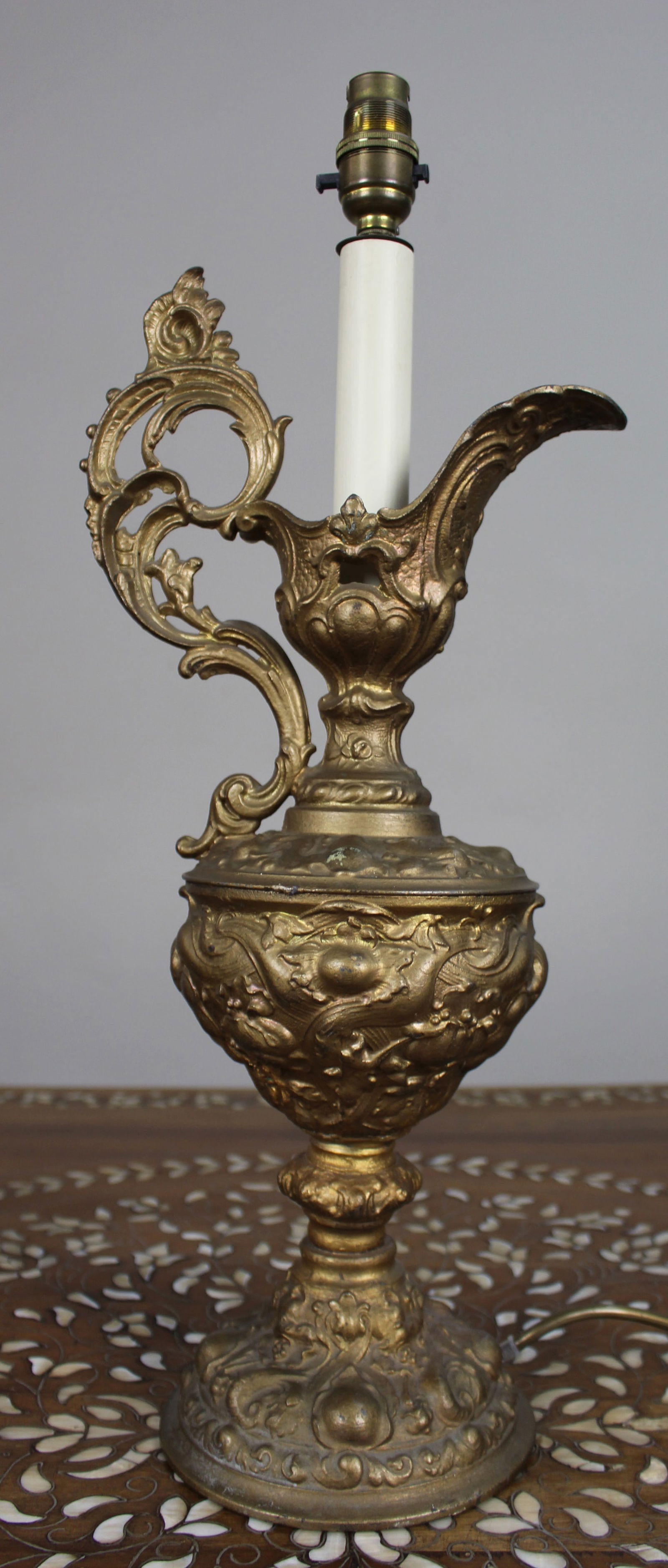Late 19th c. Gilded Metal Ewer Lamp – Later Electrified: Title: Late 19th c. Gilded Metal Ewer Lamp – Later Electrified Description: Gilt Metal Ewer Lamp, c.1900 A decorative gilt metal ewer of Rococo Revival design, dating to aroun