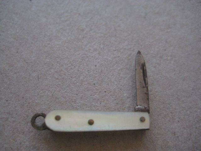 Miniature Mother of Pearl Hafted Steel Bladed Folding Fruit Knife: Title: Miniature Mother of Pearl Hafted Steel Bladed Folding Fruit Knife Description: Miniature Mother of Pearl Hafted Steel Bladed Folding Fruit Knife. Dates to around 1950.