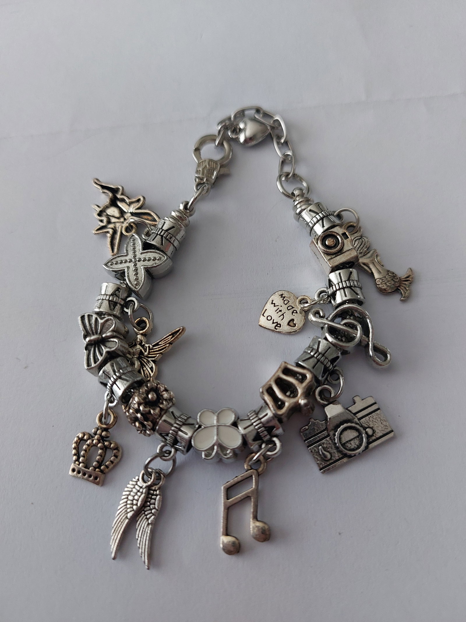 Charm Bracelet With 16 Charms: Title: Charm Bracelet With 16 Charms Description: Silver colour charm bracelet with 16 charms included Condition: Used Delivery option: Collection & Delivery Location: ME13 Category: Collectables