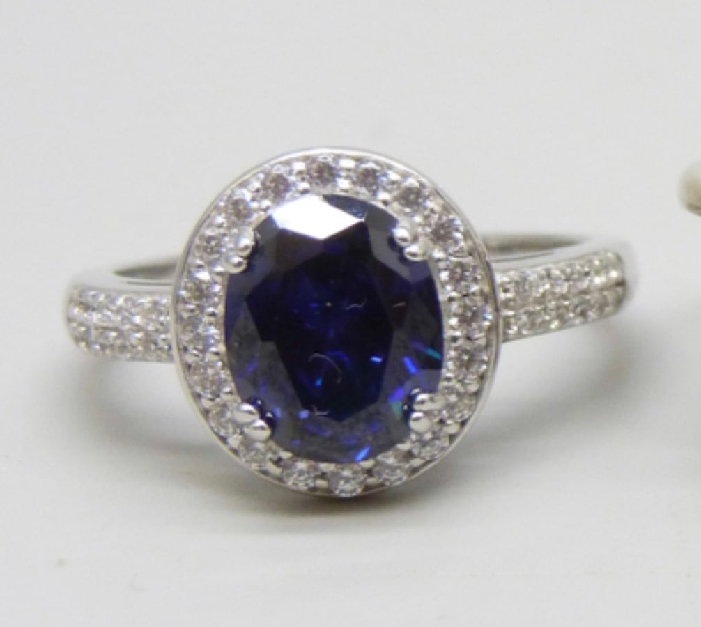 Silver Ring With CZ and Blue Stone, 4 grams, Q: Title: Silver Ring With CZ and Blue Stone, 4 grams, Q Description: Silver ring - stamp 925, CZ Weight - 4 grams Size Q/ R - 19 mm diameter Delivery - £5 Like new Condition: Used