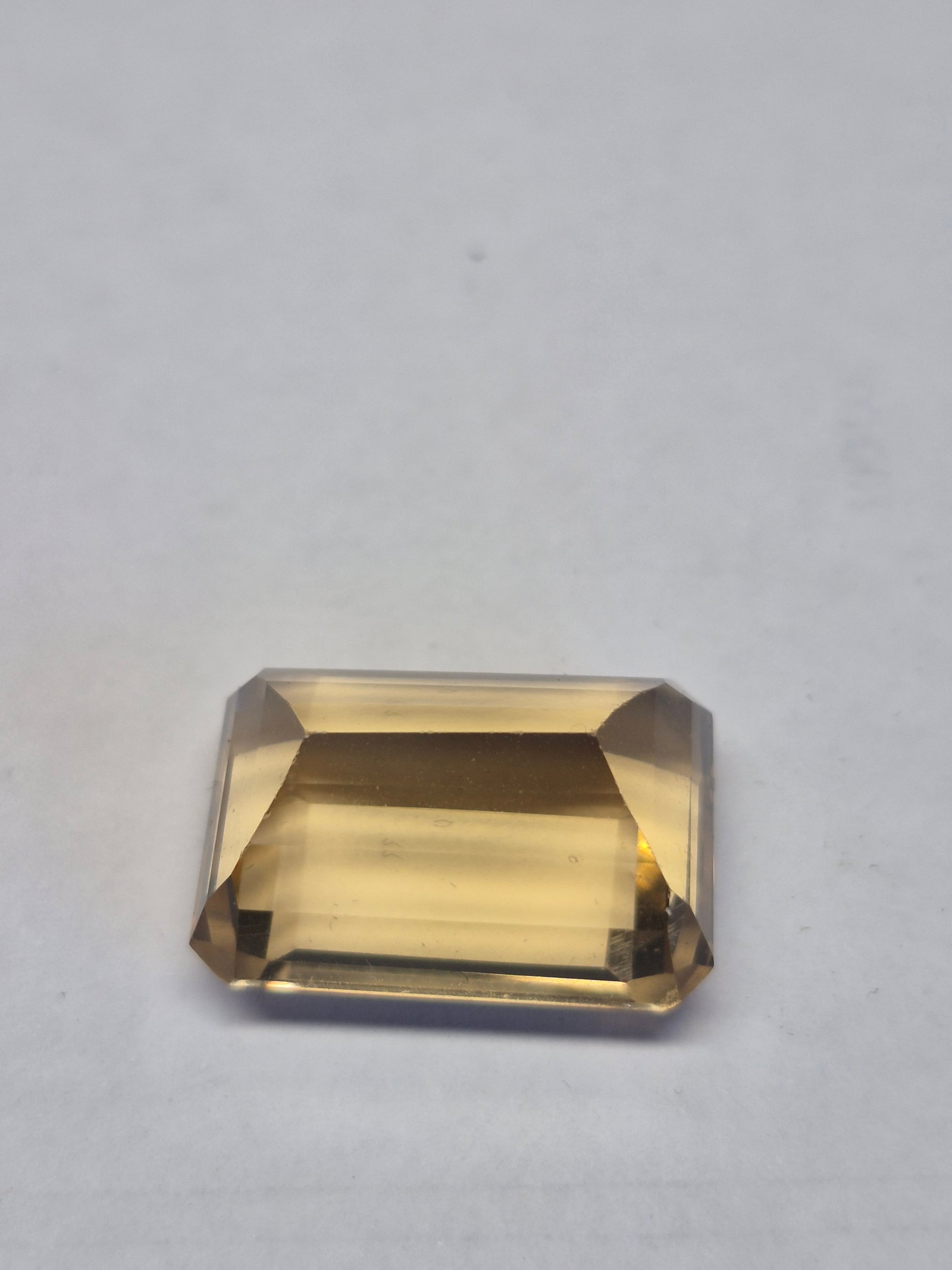 Natural Citrine Emerald Cut Gemstone 31.00 Ct 22x15 mm Loose Stone: Title: Natural Citrine Emerald Cut Gemstone 31.00 Ct 22x15 mm Loose Stone Description: Beautiful natural citrine gemstone featuring a classic emerald cut with excellent transparency and a warm