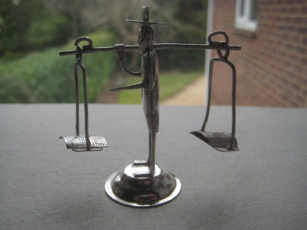 Chinese Miniature White Metal Gentleman Carrying Cheese: Title: Chinese Miniature White Metal Gentleman Carrying Cheese Description: Chinese Miniature White Metal Gentleman carrying cheese. Stamped Made in Hong Kong on the base. Height is 2.75