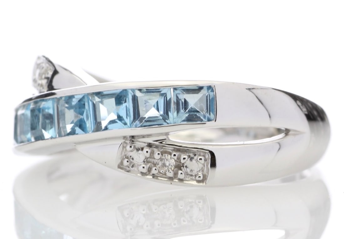 9Ct White Gold Blue Topaz and Diamond Ring (BT1.50) 0.02 Carats: Title: 9Ct White Gold Blue Topaz and Diamond Ring (BT1.50) 0.02 Carats Description: This twist on a classic ring is stunning. Seven beautiful princess cut blue topaz gemstones with six round