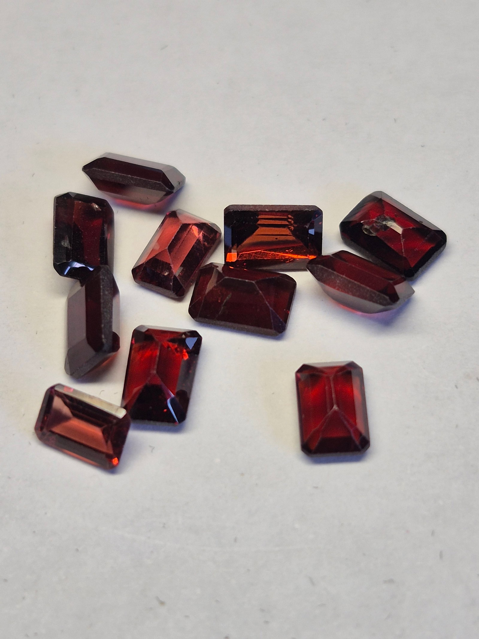 Natural Garnet Lot 8.60 Ct – Emerald Cut 6x4 mm Deep Red Gemstones: Title: Natural Garnet Lot 8.60 Ct – Emerald Cut 6x4 mm Deep Red Gemstones Description: Beautiful lot of natural garnet gemstones in a classic emerald-cut shape. These stones display a